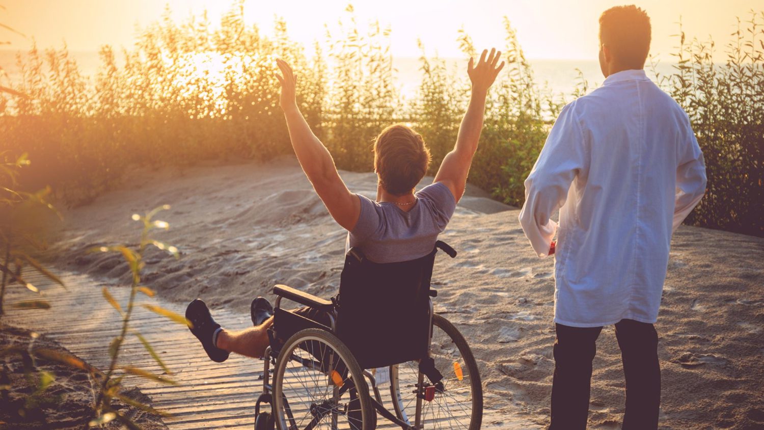 man-wheelchair-his-nurse-enjoying-sunrise-beach